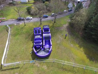 curved giant inflatable assault course - birds eye view drone