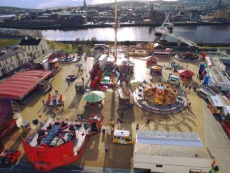 arial view of Ebrington event in Northern Ireland - funfair rides and games and fairground side stalls